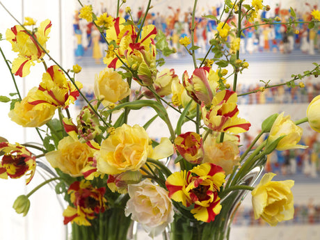 Påskvas närbild med gula tulpaner, påskliljor (Tête‑à‑tête), pärlhyacinter och björkris – vårblommor för påskbordet; inspiration, påskdekoration och skötselråd för lökväxter.