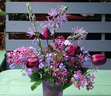 Preserving lilacs as cut flowers: rustic lilac bouquet with scraped woody stems soaked in warm water for better uptake, arranged with elderflowers, lupines and lady’s mantle; avoid daffodils/narcissus.